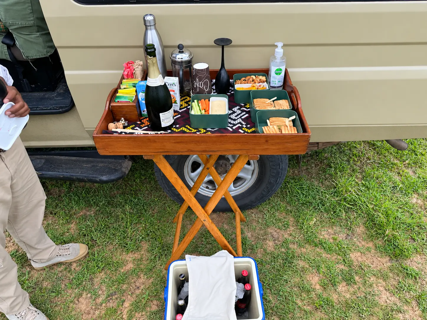 Arrival refreshments beside a Four Seasons Safari Lodge Serengeti safari vehicle