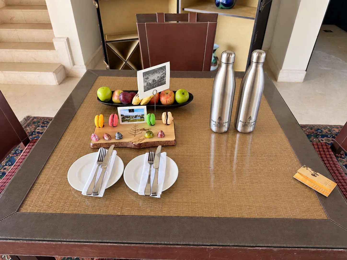Four Seasons Preferred Partner welcome amenity with fruit, macarons, chocolates and reusable water bottles at Four Seasons Safari Lodge Serengeti.