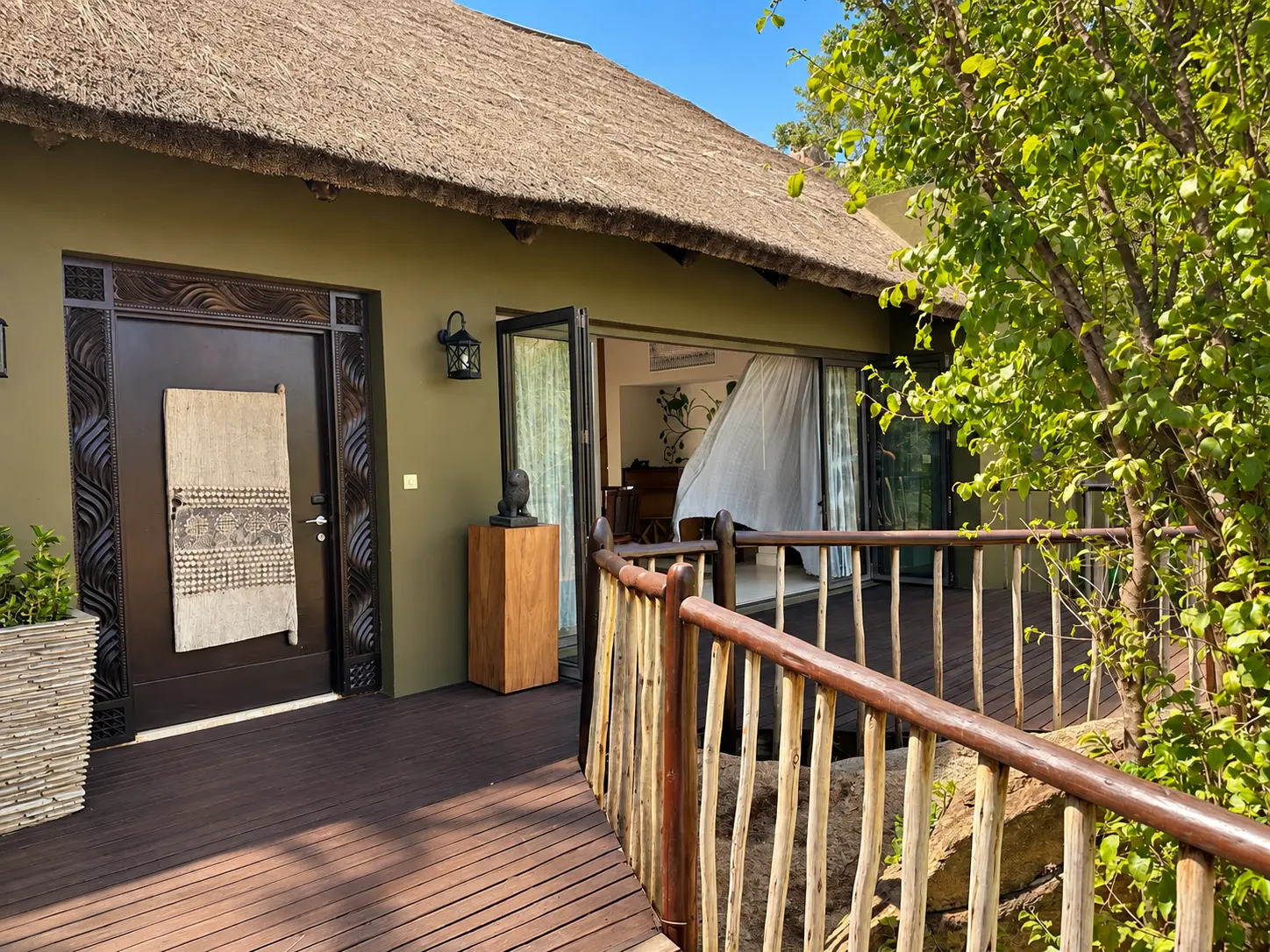 Front entrance and wooden walkway of a One-Bedroom Villa at Four Seasons Safari Lodge Serengeti in Tanzania.