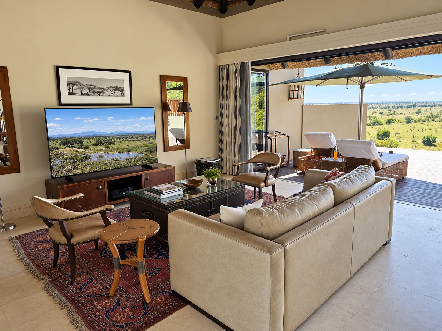Living room and entertainment area inside a One-Bedroom Villa at Four Seasons Safari Lodge Serengeti in Tanzania.