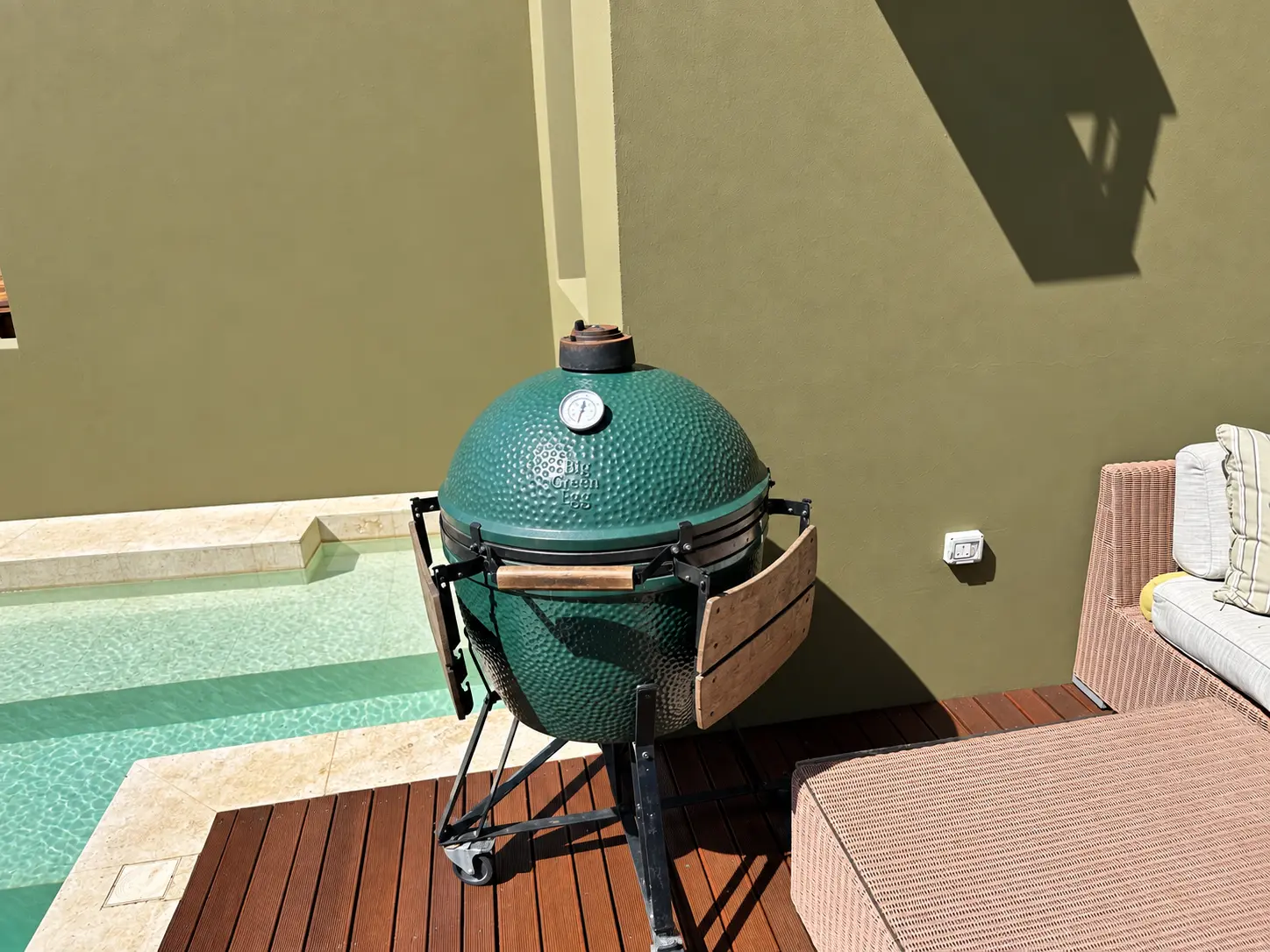 ig Green Egg grill beside the private pool at a One-Bedroom Villa at Four Seasons Safari Lodge Serengeti, used for customized in-villa dining.