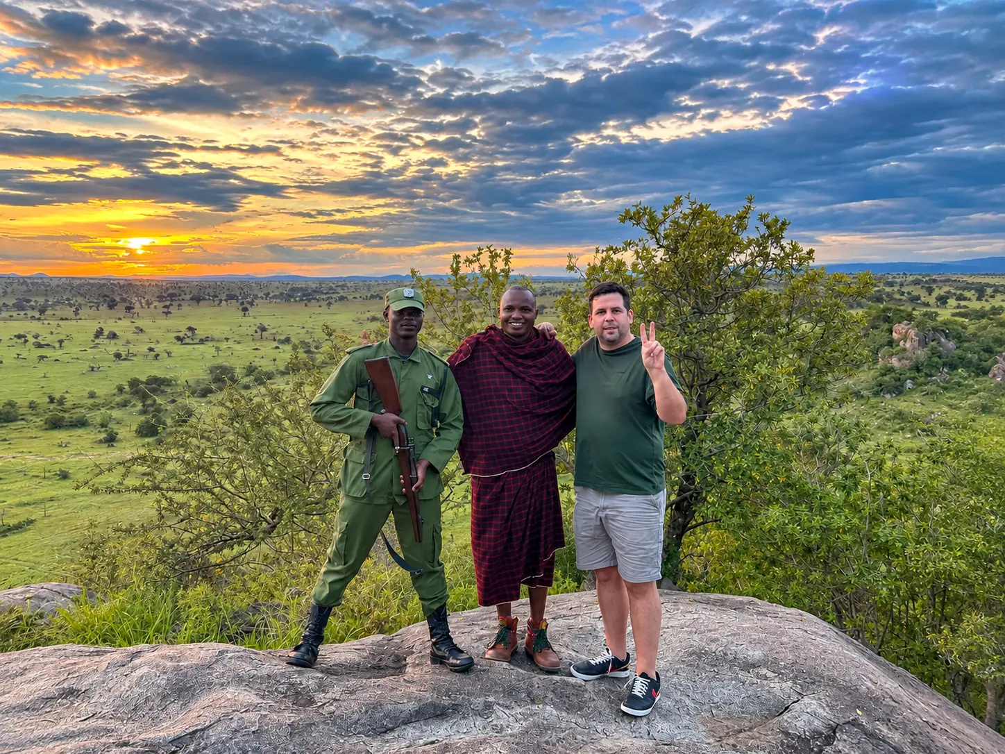 Sunset over the Serengeti plains with a ranger, Maasai guide and guest at Four Seasons Safari Lodge Serengeti in Tanzania.