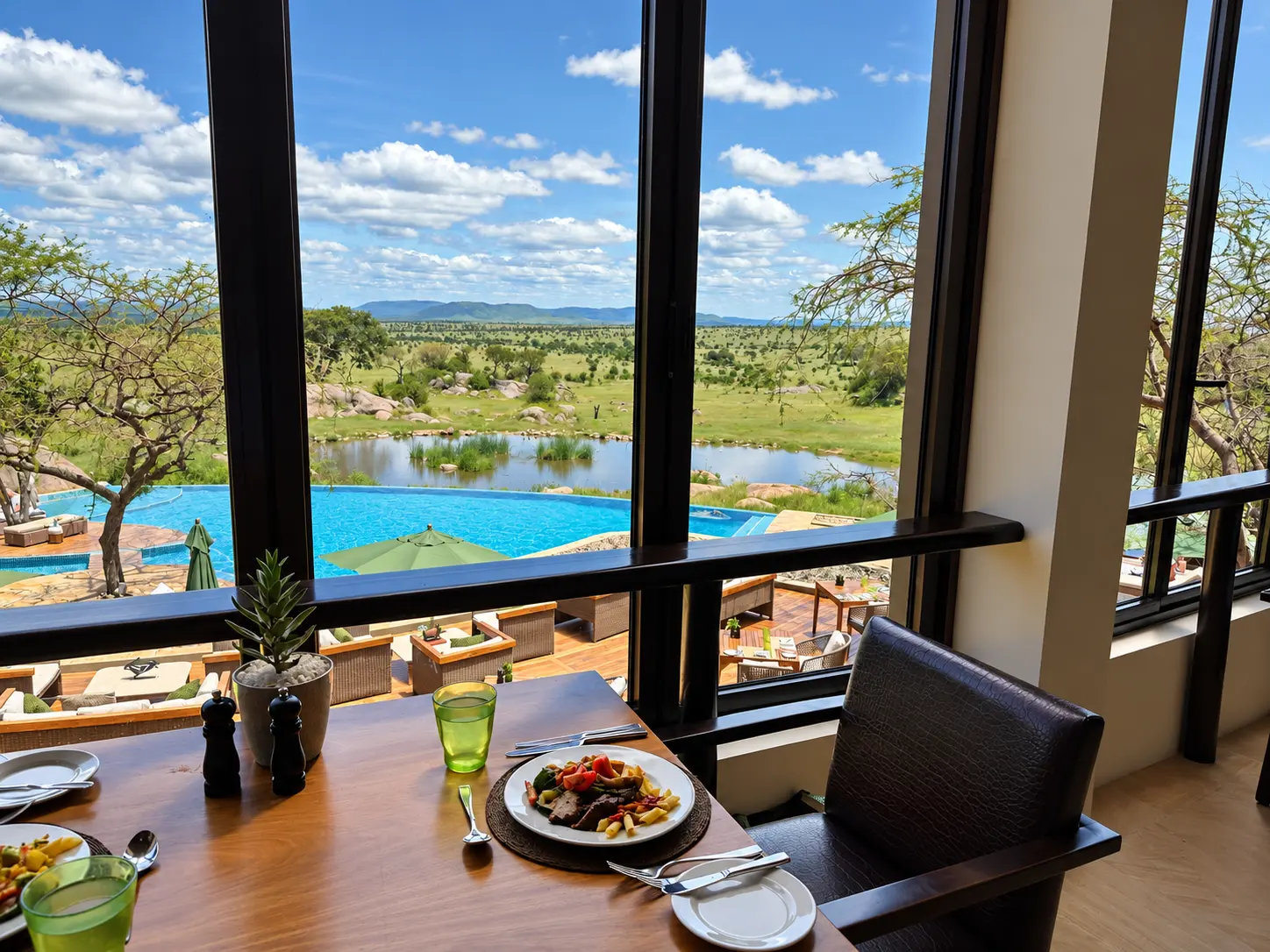 Breakfast overlooking the pool, waterhole and Serengeti plains at Four Seasons Safari Lodge Serengeti.