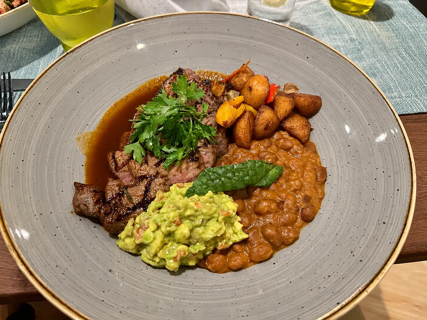Steak dinner with beans, potatoes and guacamole at Nuru at Feasons Safari Lodge Serengeti.