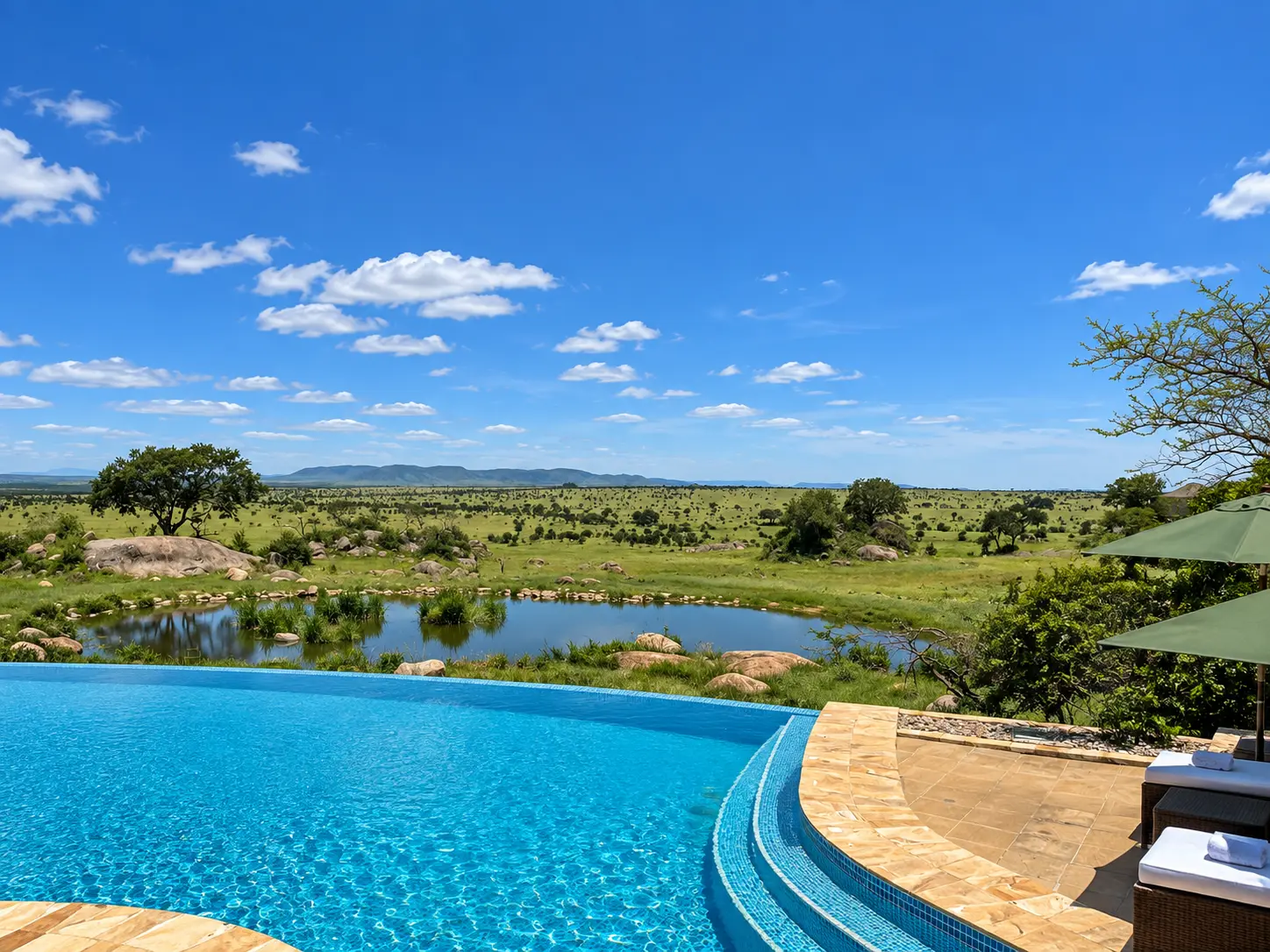 Infinity pool overlooking the waterhole and Serengeti plains at Four Seasons Safari Lodge Serengeti in Tanzania.