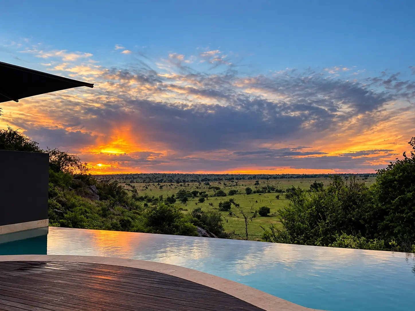 Sunset over the Serengeti from our private villa infinity pool at Four Seasons Safari Lodge Serengeti.