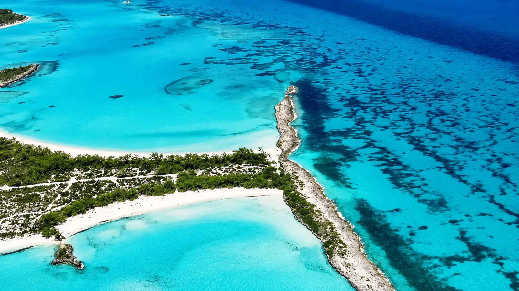 Aerial view of turquoise water and white-sand islands in the Exumas, Bahamas