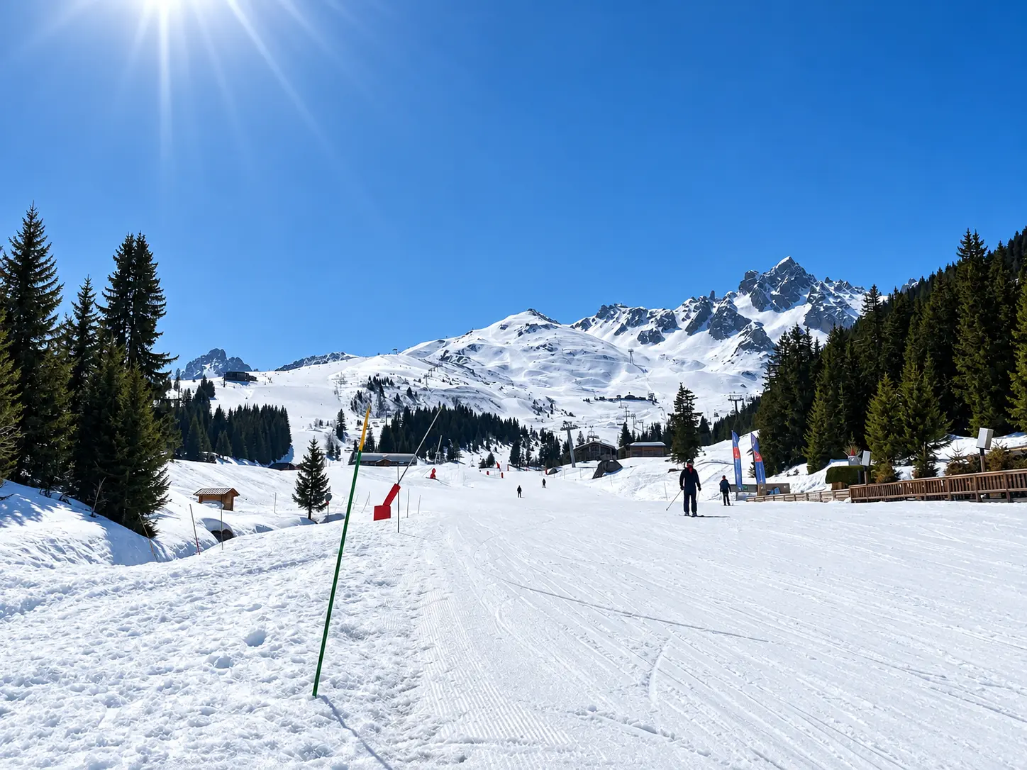 Bellecôte ski area in Courchevel 1850 with groomed snow, pine forest and Alpine mountain views.