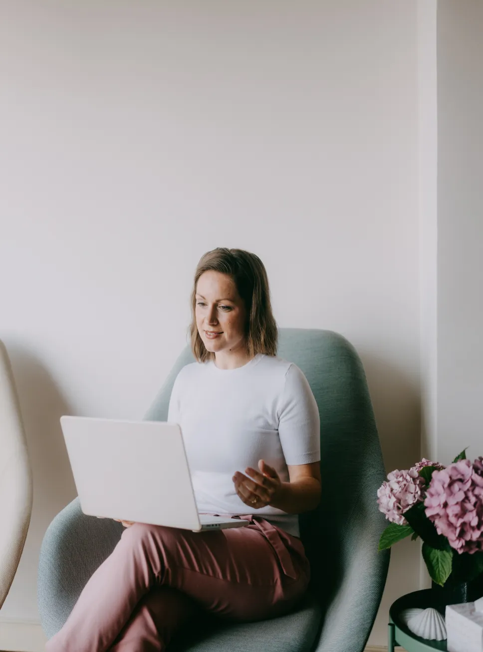 Woman on a virtual therapy session from her armchair at home