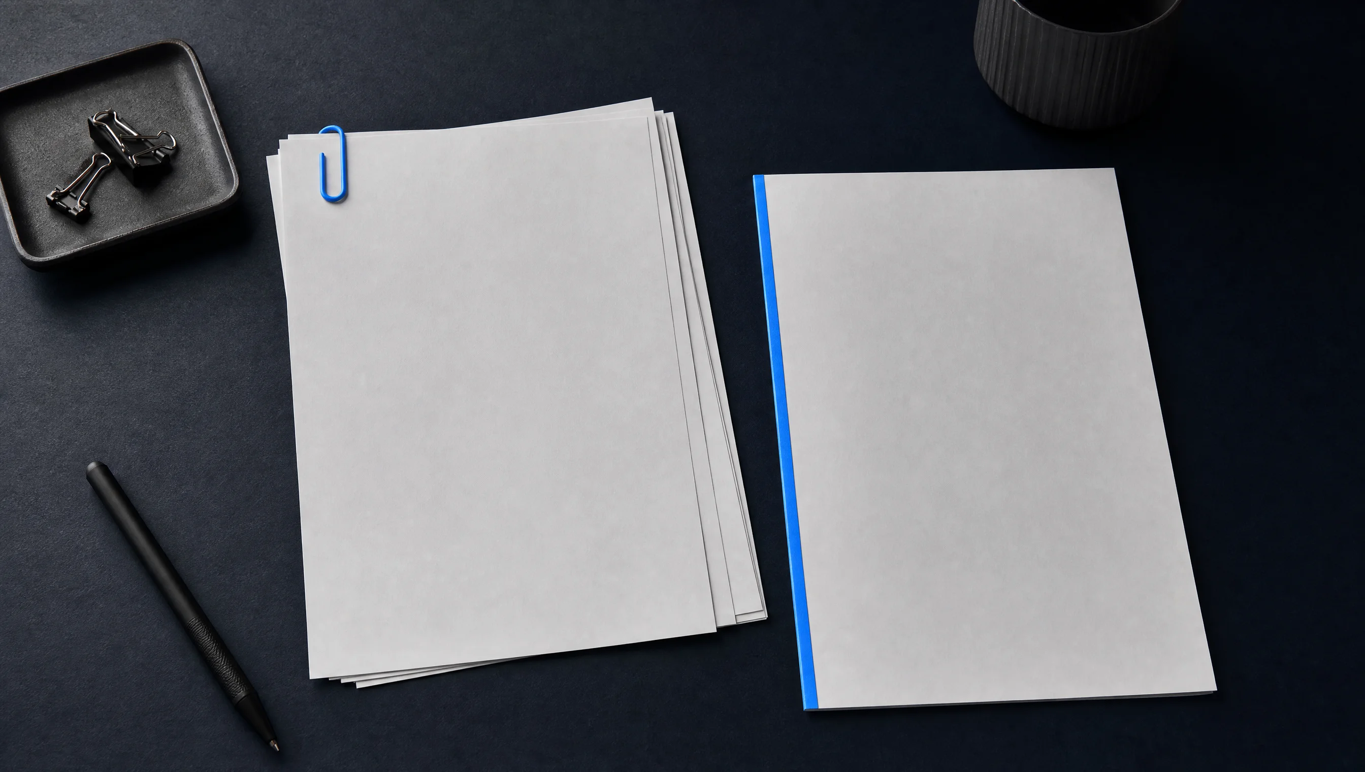 Photo of a stack of invoices and a quote document on a dark desk, with one document highlighted