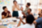 Colleagues applauding a team member during a recognition moment at work