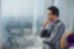 Business leader reflecting on employee incentives and rewards strategy in a modern office
