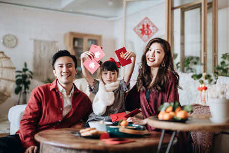 Family showcasing all the red envelopes they received for the Chinese new year celebrations
