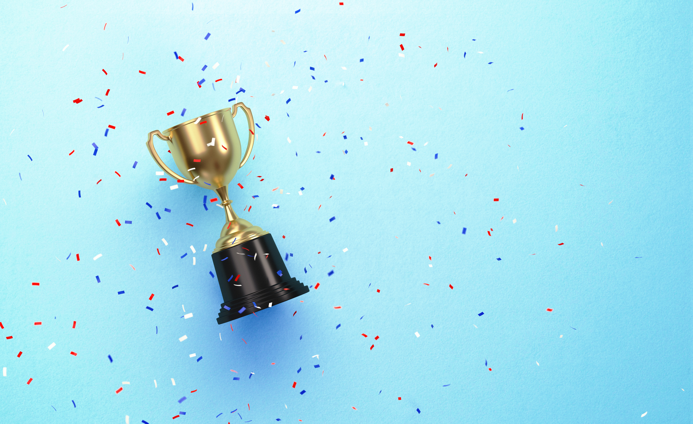 A prize cup and confetti over a blue background