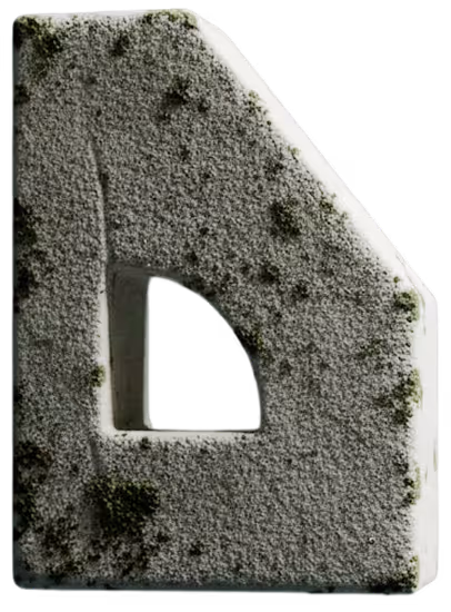 Block of gray porous stone with a triangular and rectangular cutout.