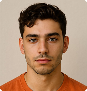 Portrait of a young man with short curly dark hair wearing an orange shirt against a beige background.