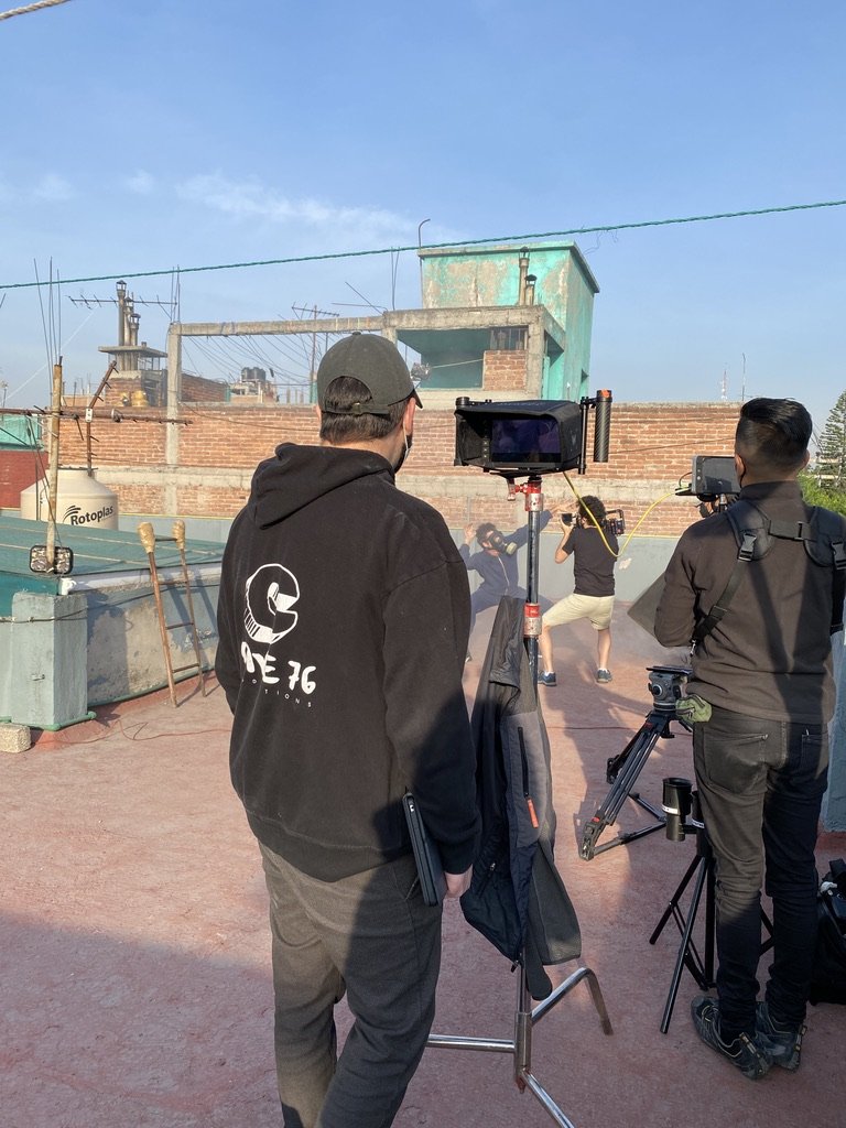 Three people standing outdoors in an industrial area