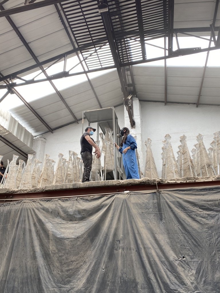 Person standing inside a large warehouse or industrial building