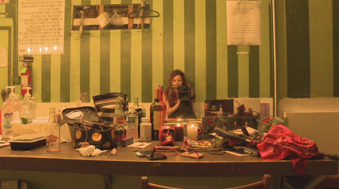 A performer at her cluttered dressing table backstage at the Coney Island Circus Sideshow