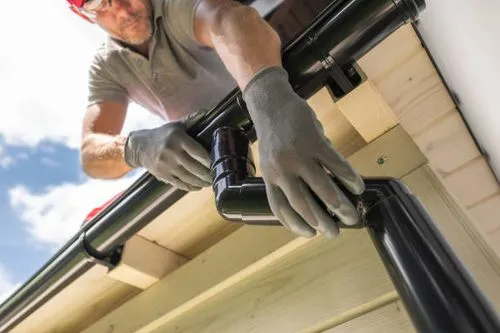 A professional installing a Gutter in Springfield, MO.