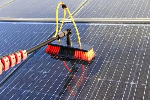 A professional cleaning a solar panel in Springfield, MO.