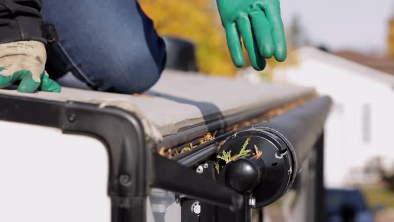 A professional inspecting a Gutter in Springfield, MO.