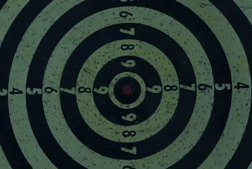 Archery target, with rings of black and green, and numbers at each line.