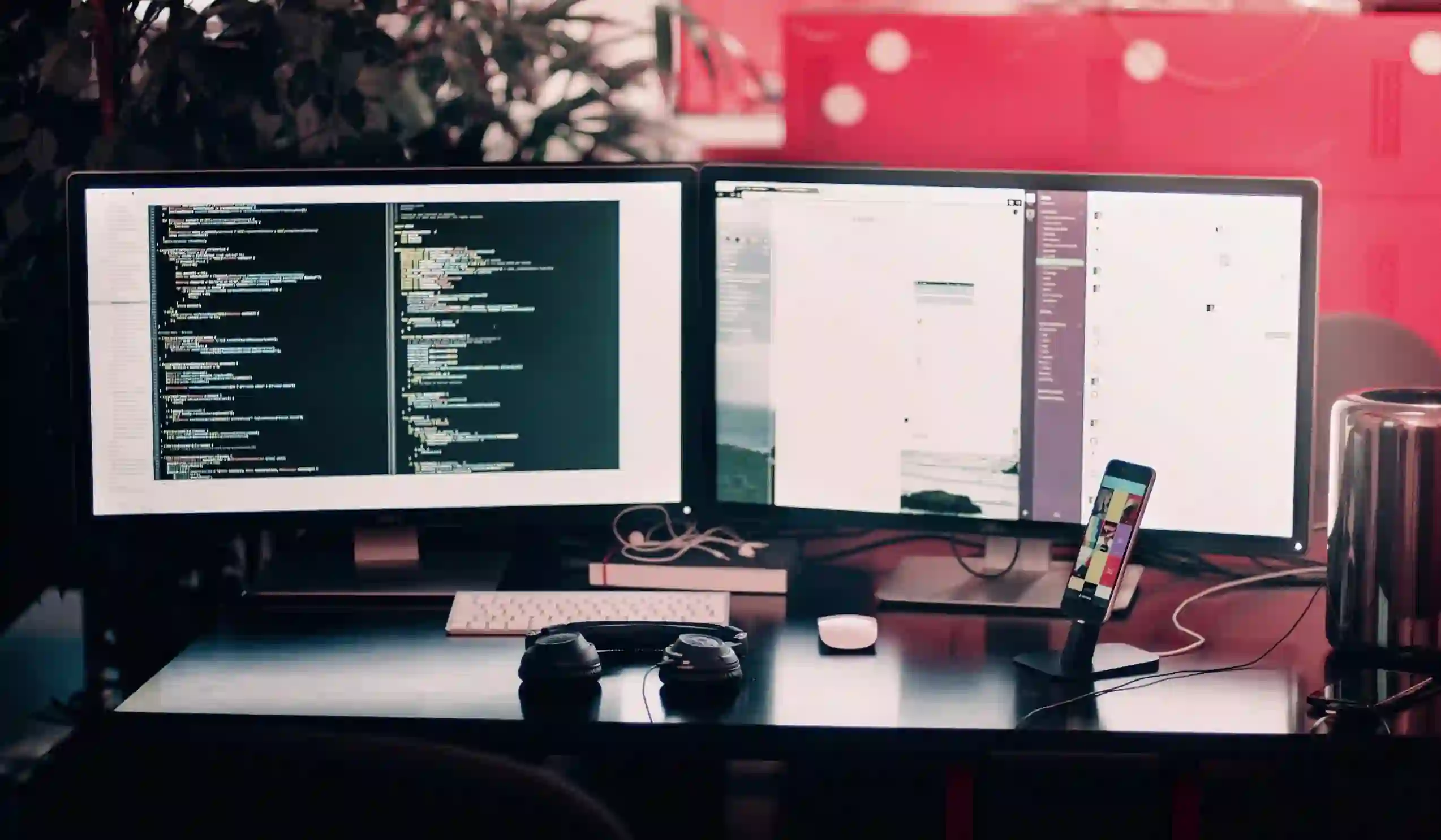 Developer workstation setup with dual monitors showing code and workplace apps.