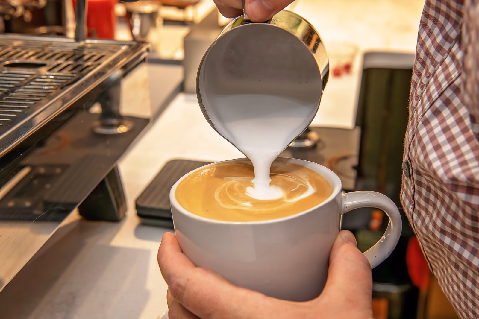 Barista pouring a latte at The Market, Chesapeake Bay Beach Club