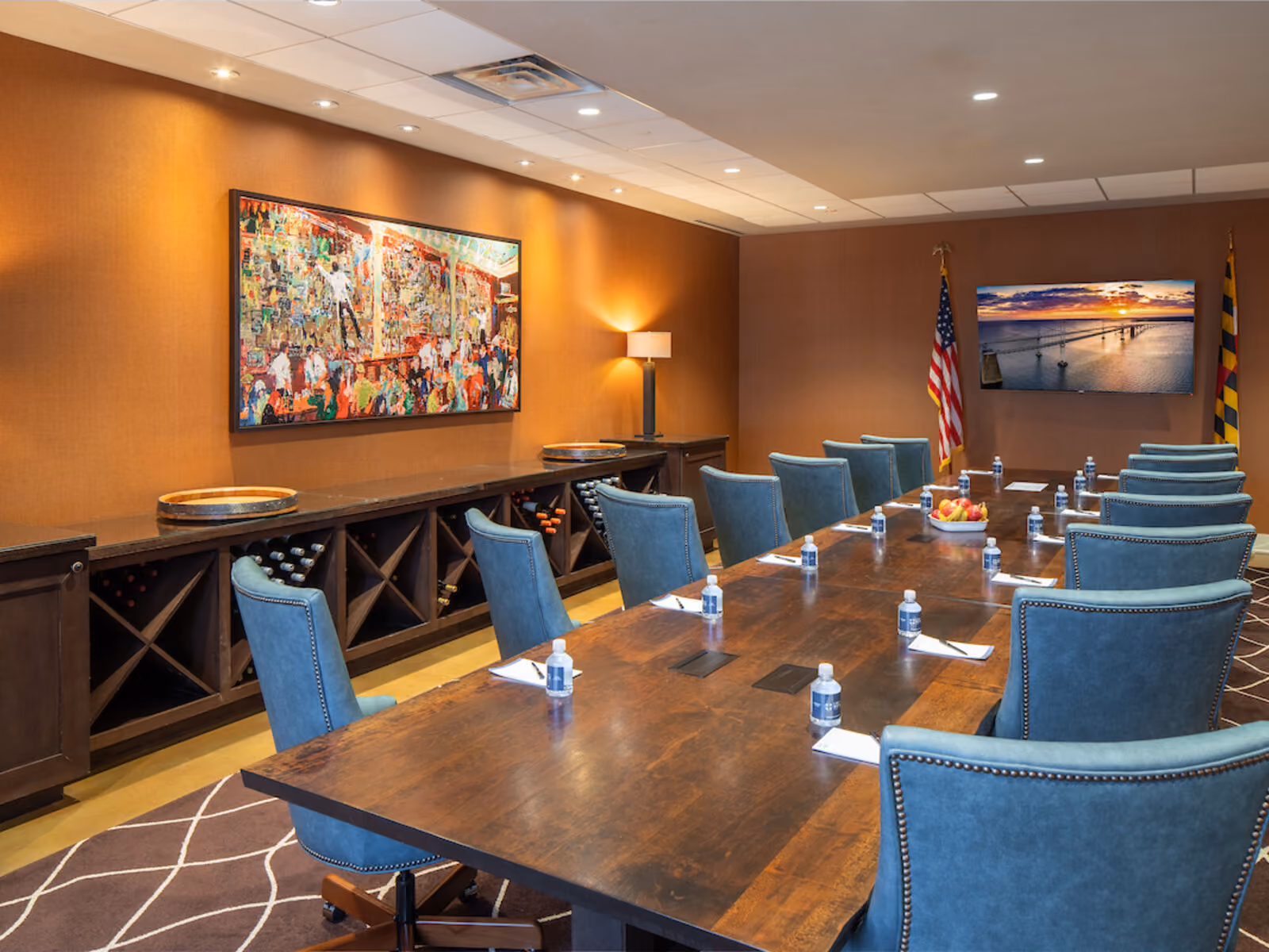 The Boardroom at The Inn featuring a custom wood conference table, leather executive chairs, and a gas fireplace at Chesapeake Bay Beach Club