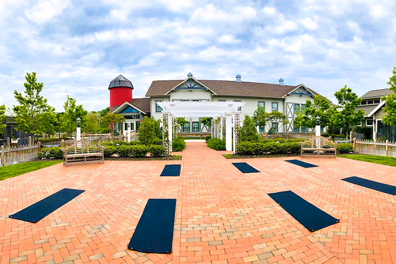 Outdoor yoga class in The Inn Courtyard on a sunny morning at Chesapeake Bay Beach Club, Eastern Shore Maryland