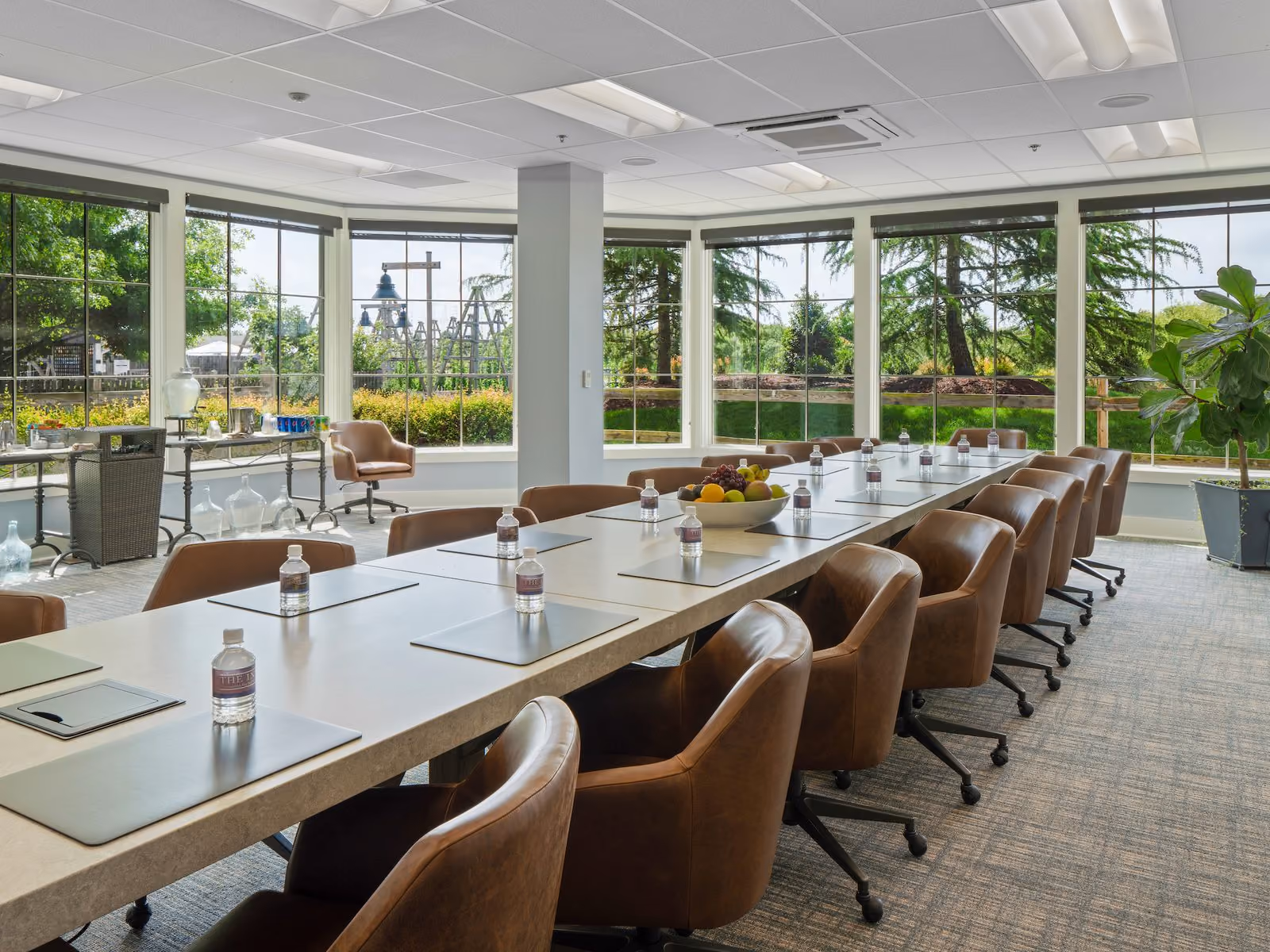 Corporate conference room with a long boardroom table, leather chairs and panoramic Bay Bridge views