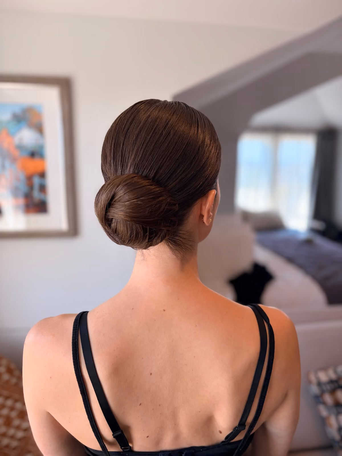 Sleek low chignon bridal updo at Chesapeake Bay Beach Club