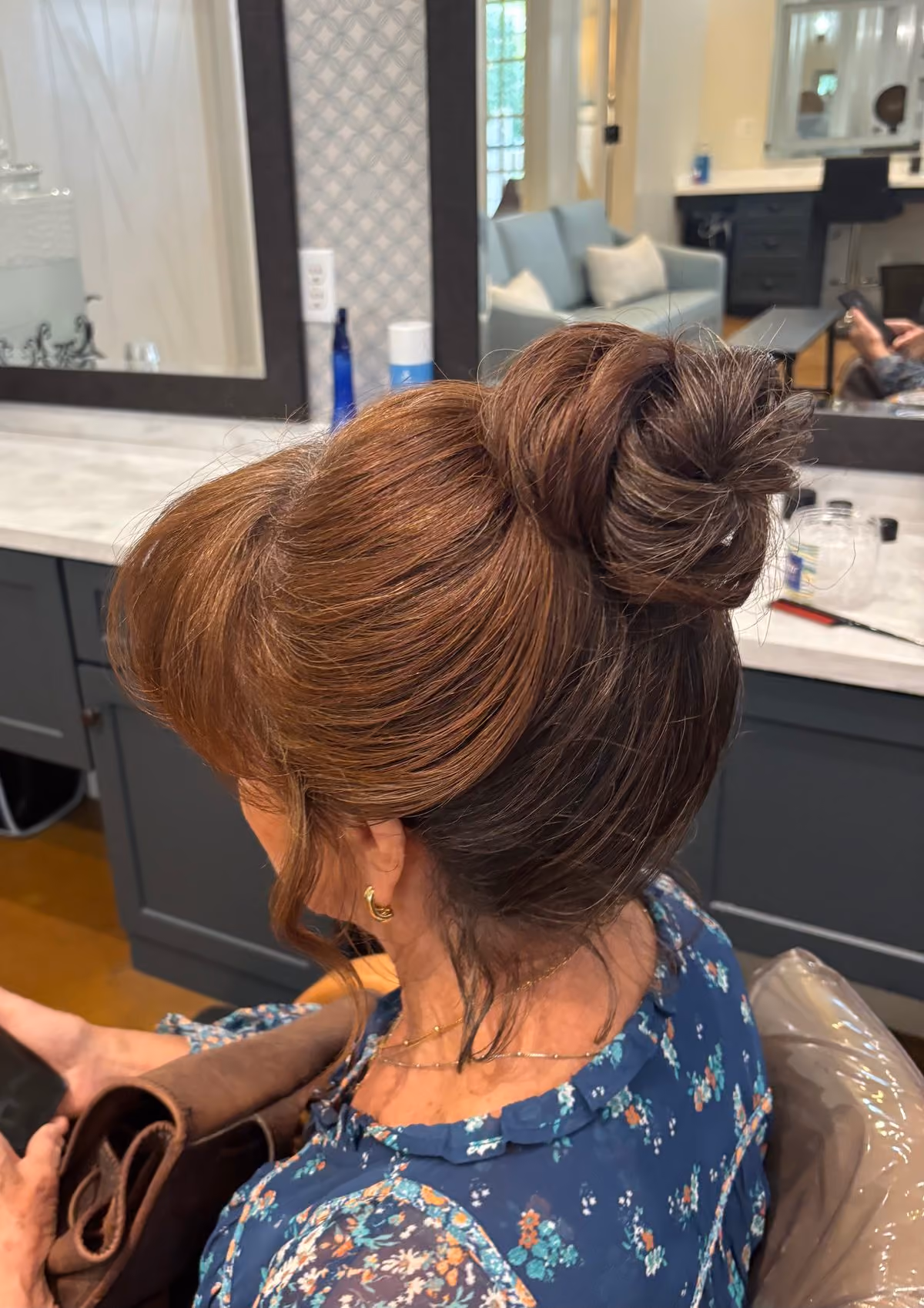 Voluminous brunette topknot bridal updo at Chesapeake Bay Beach Club