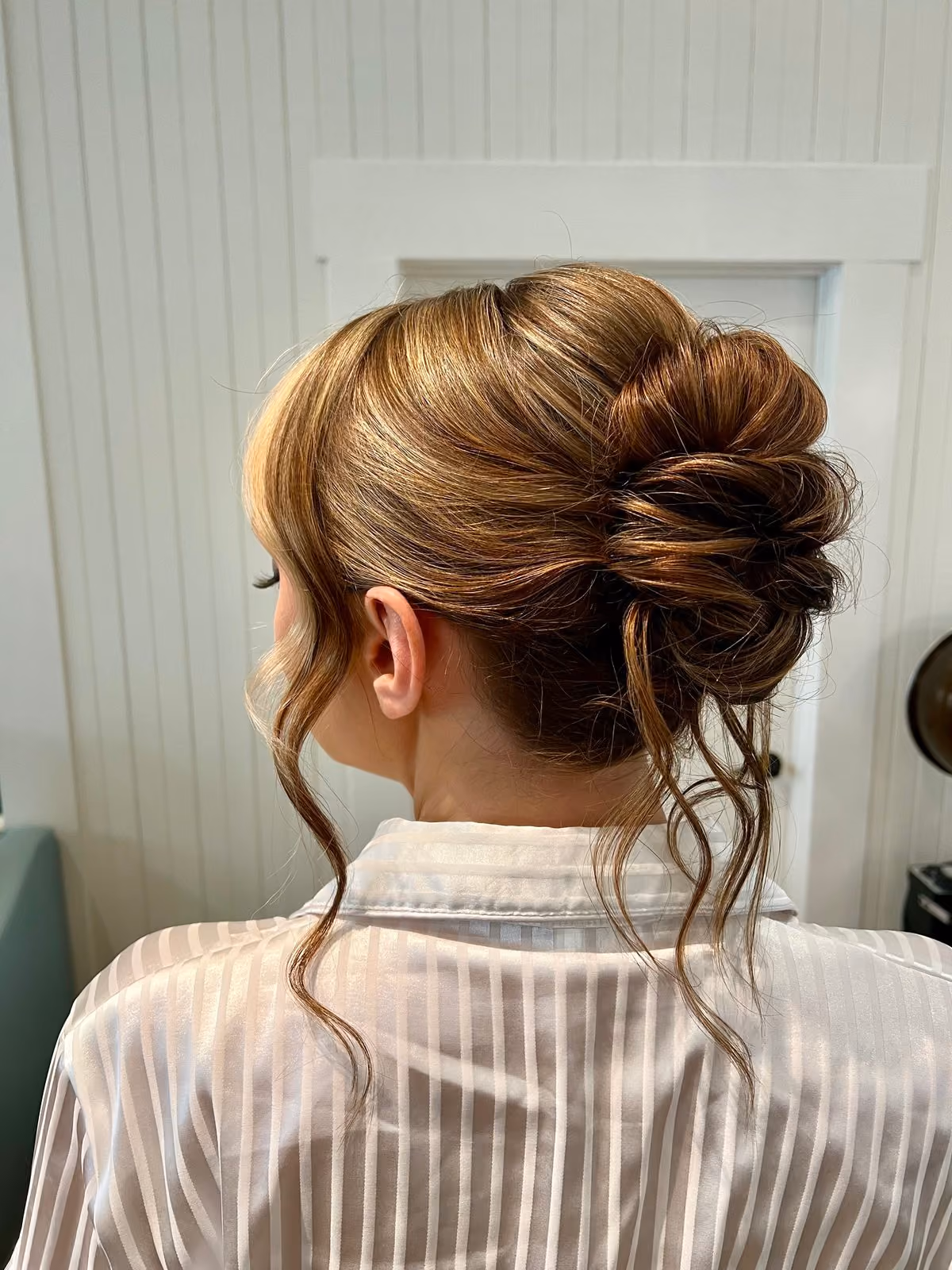 Caramel messy bridal updo with face-framing tendrils at Chesapeake Bay Beach Club