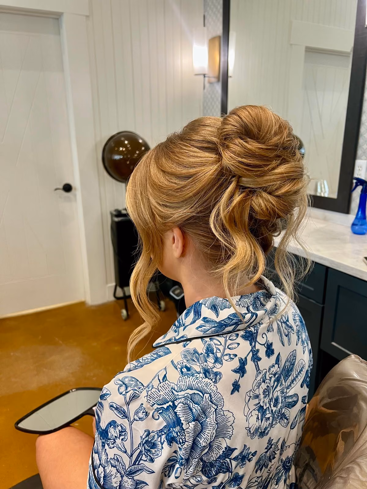 Voluminous high bridal updo with face-framing curls at Chesapeake Bay Beach Club