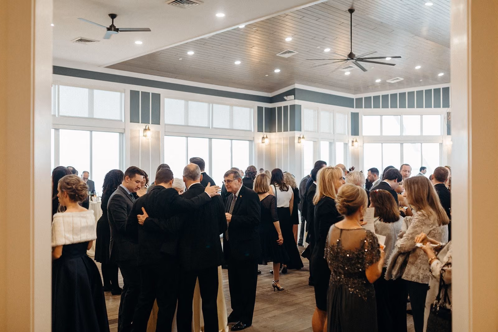Guests gathering for an event on the enclosed Garden Rooftop at Chesapeake Bay Beach Club