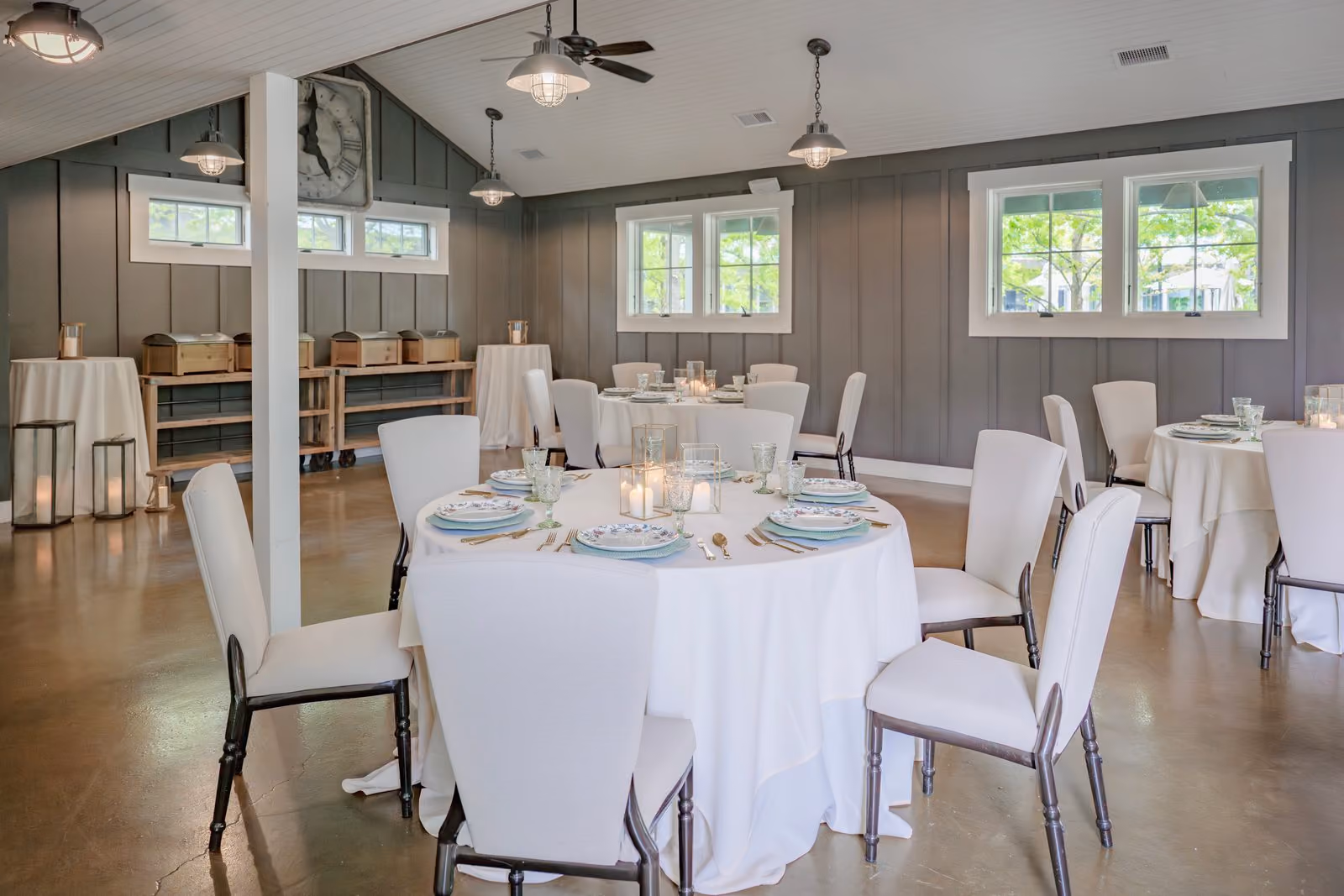 Tool Shed Bar dining table set with white linens beneath a vaulted ceiling at The Inn at Chesapeake Bay Beach Club