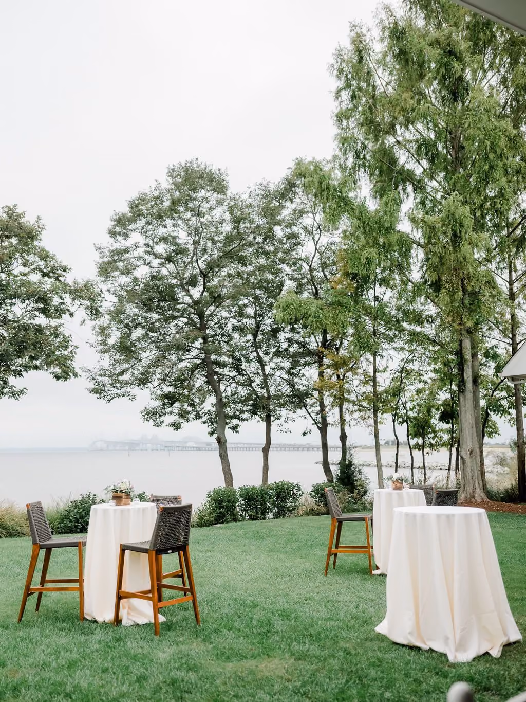 Waterfront lawn with cocktail tables beside the Sunset Ballroom at Chesapeake Bay Beach Club