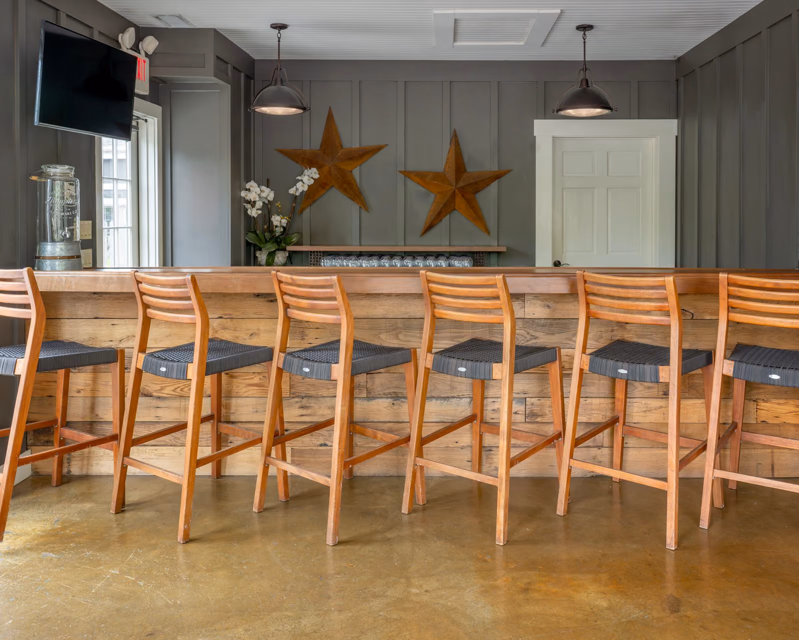 Tool Shed Bar wood bar with stools and star decor at The Inn at Chesapeake Bay Beach Club