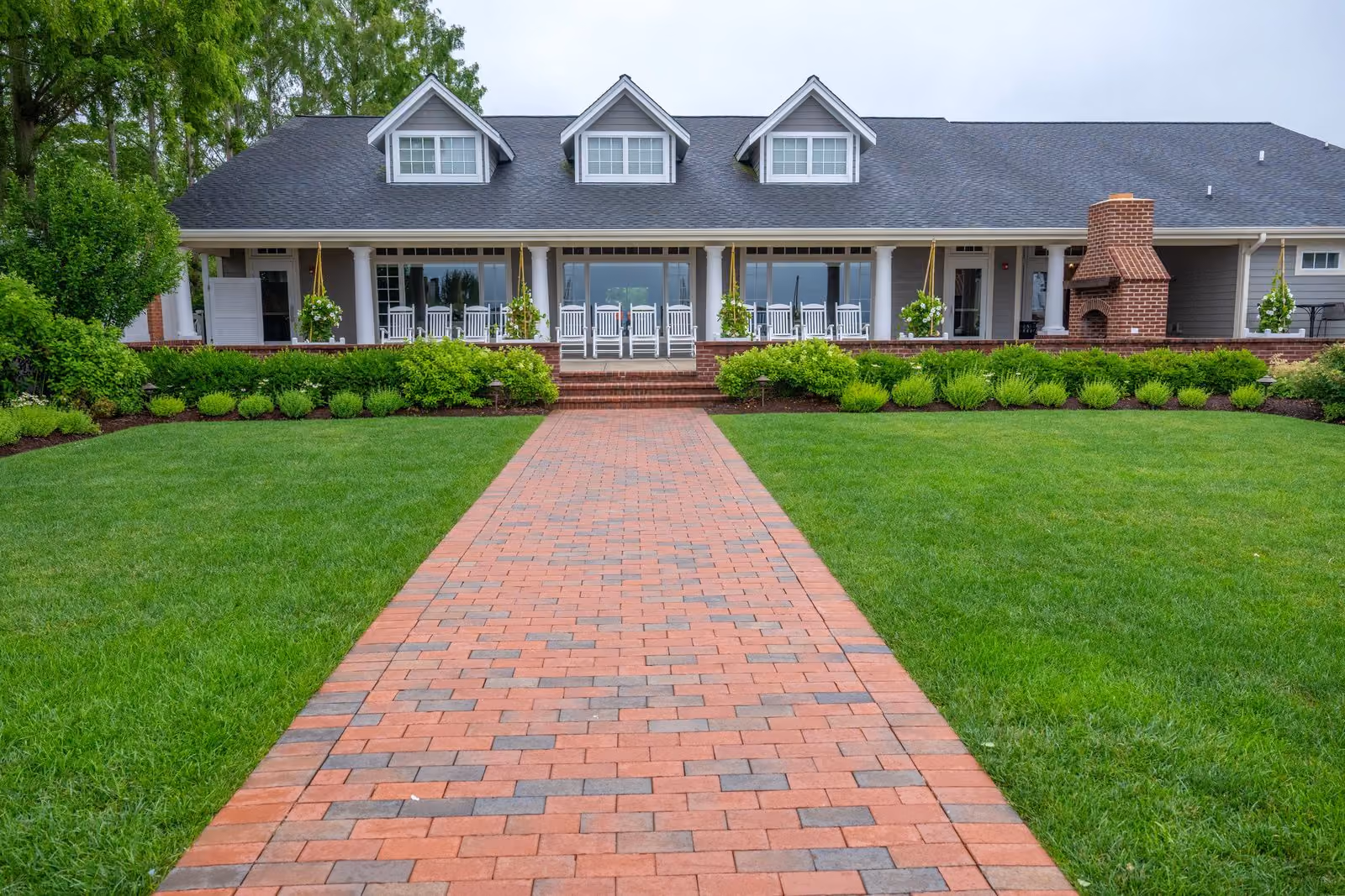 Exterior of the Beach House venue with brick walkway and manicured lawn at Chesapeake Bay Beach Club