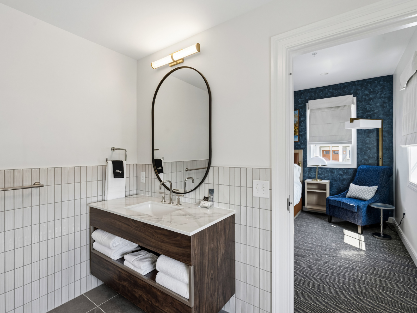 Mariner Suite bathroom at Wilson’s Cove with marble-top vanity and adjoining bedroom.