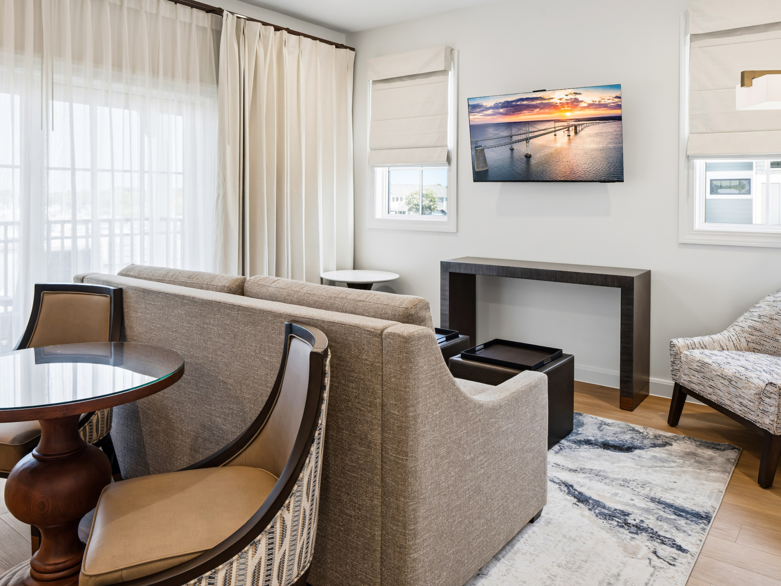 Wilson’s Cove Mariner Suite living area with wet bar, sofa and access to the private balcony.