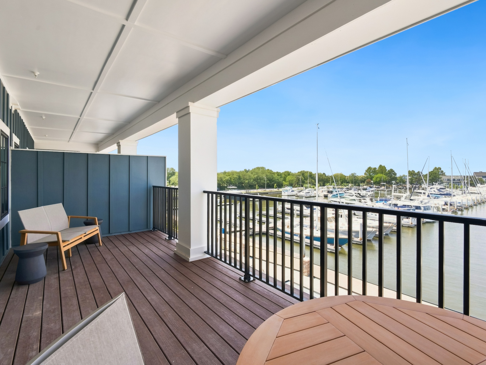Expansive private balcony at Wilson’s Cove Beacon Suite overlooking Bay Bridge Marina.