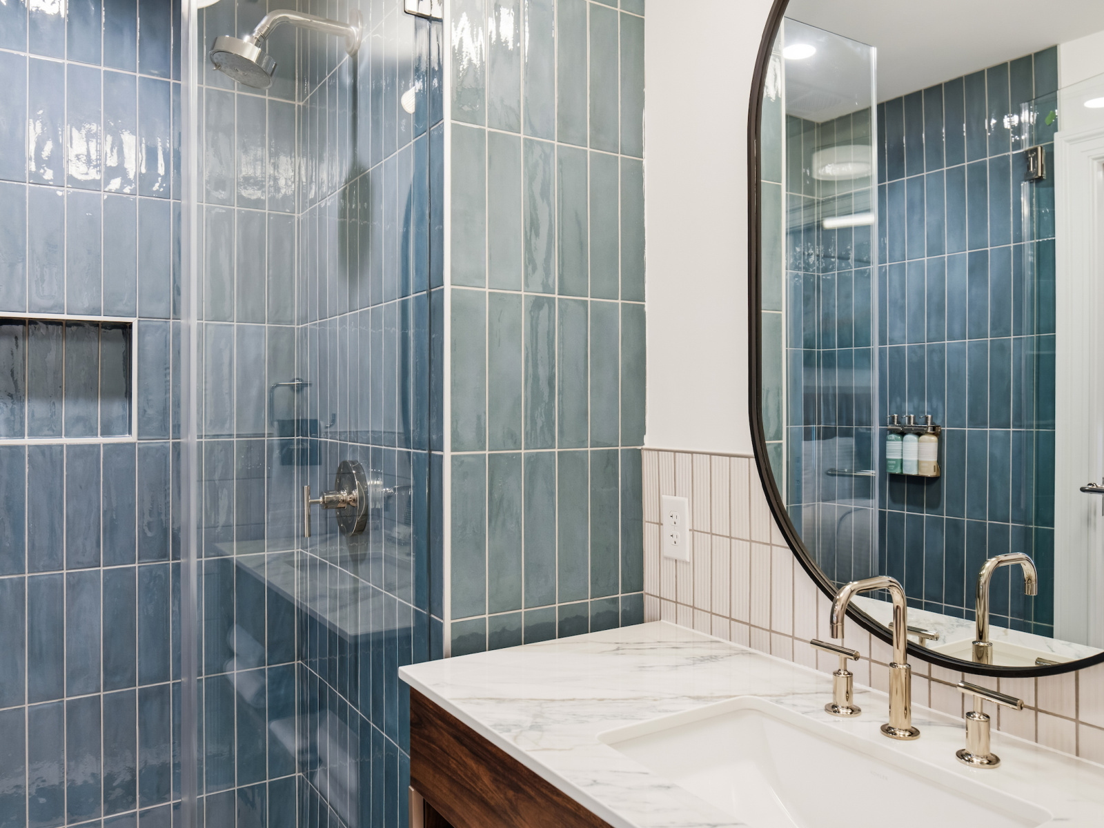 Beacon Suite bathroom at Wilson’s Cove with blue tile walk-in shower and marble-top vanity.