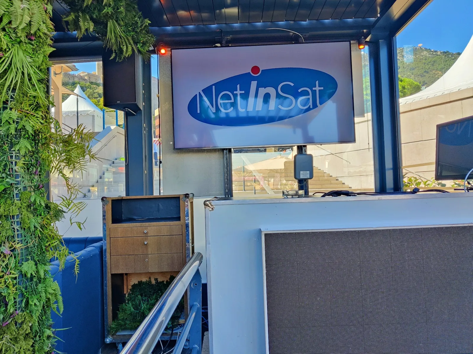 NetInSat logo on screen in an event lounge