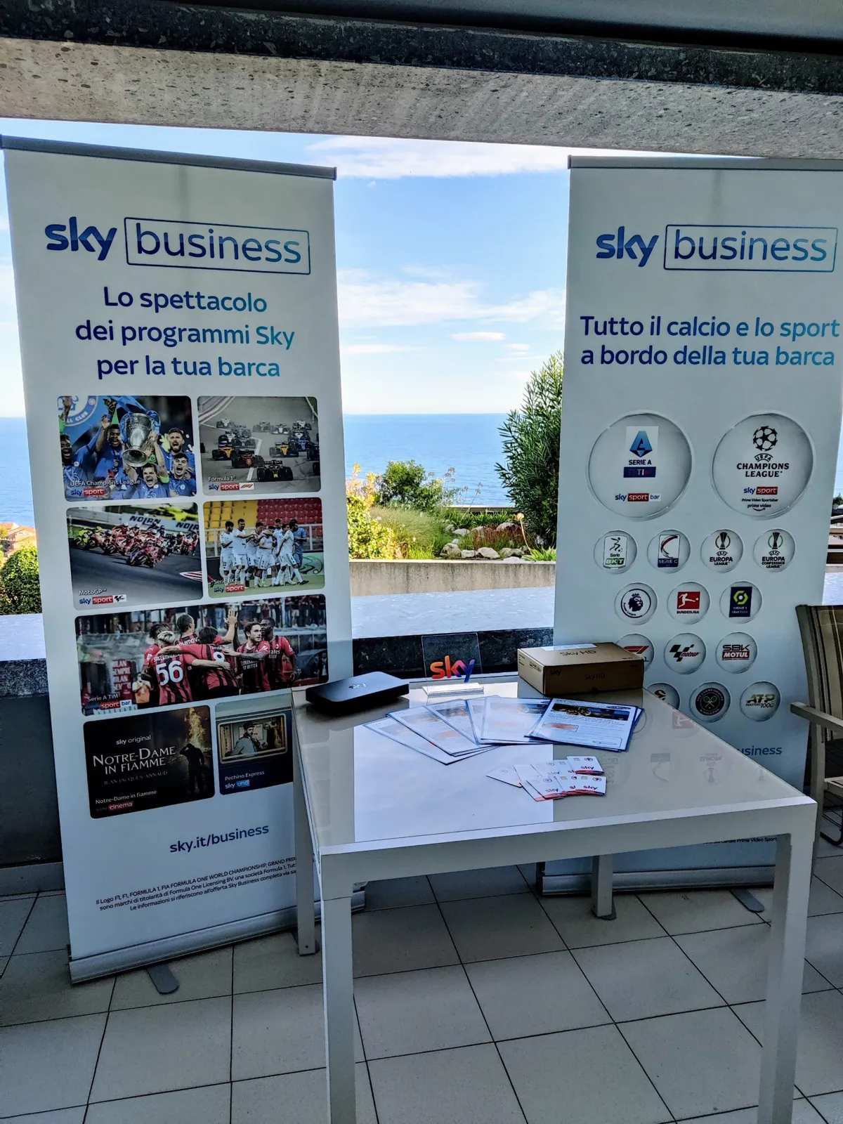 NetInSat stand with Sky Business banners for yachts, overlooking the sea