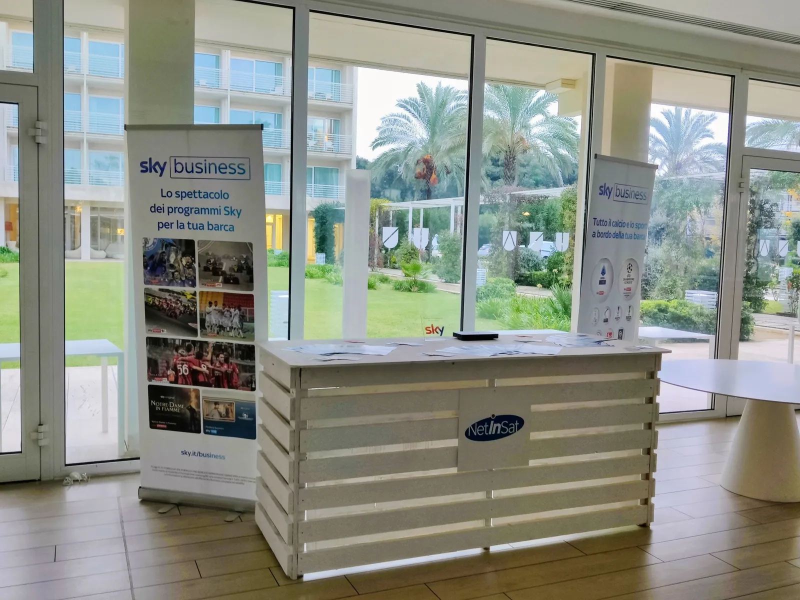 NetInSat desk with Sky Business banners at an industry event