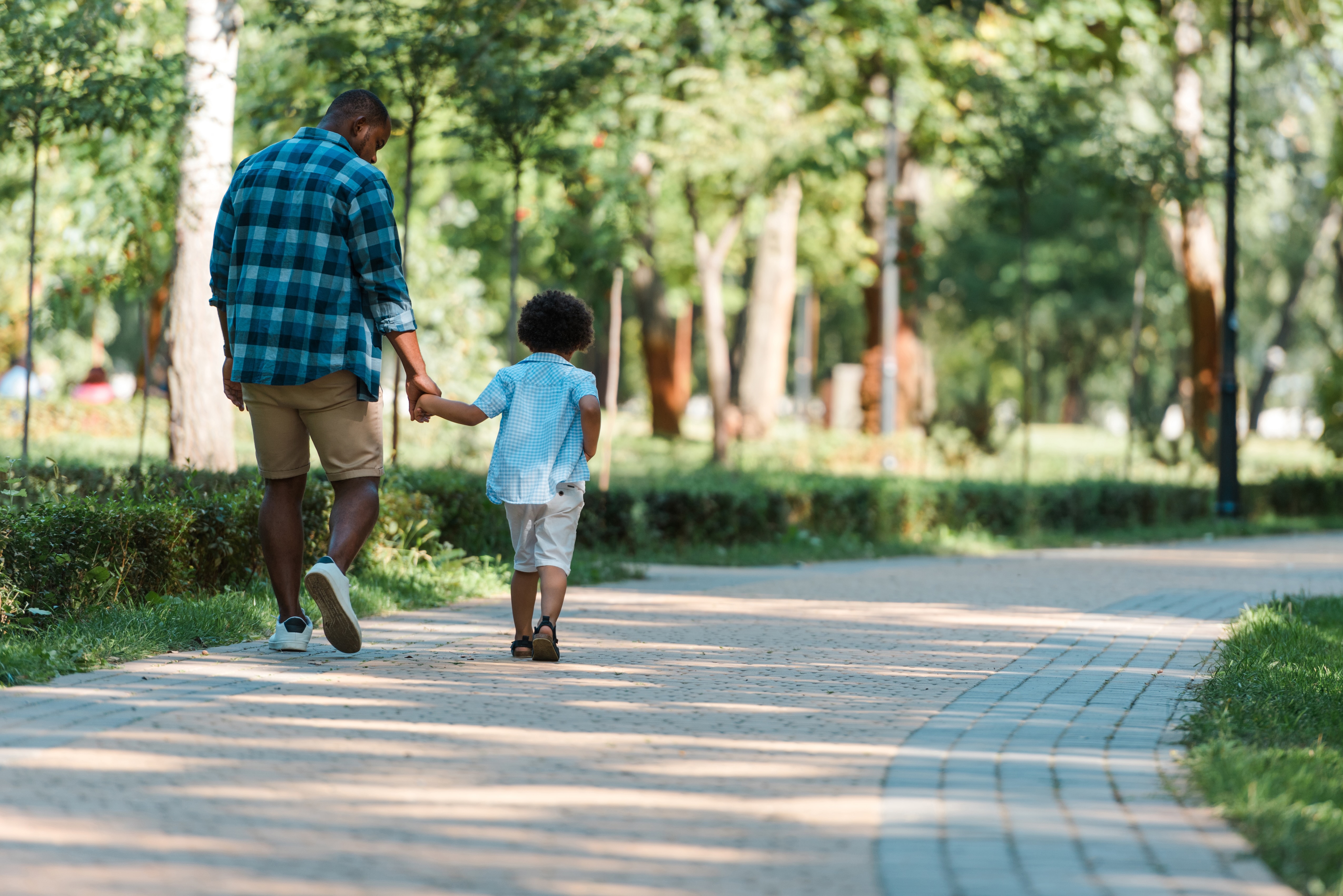 Man walking with child outside stock image