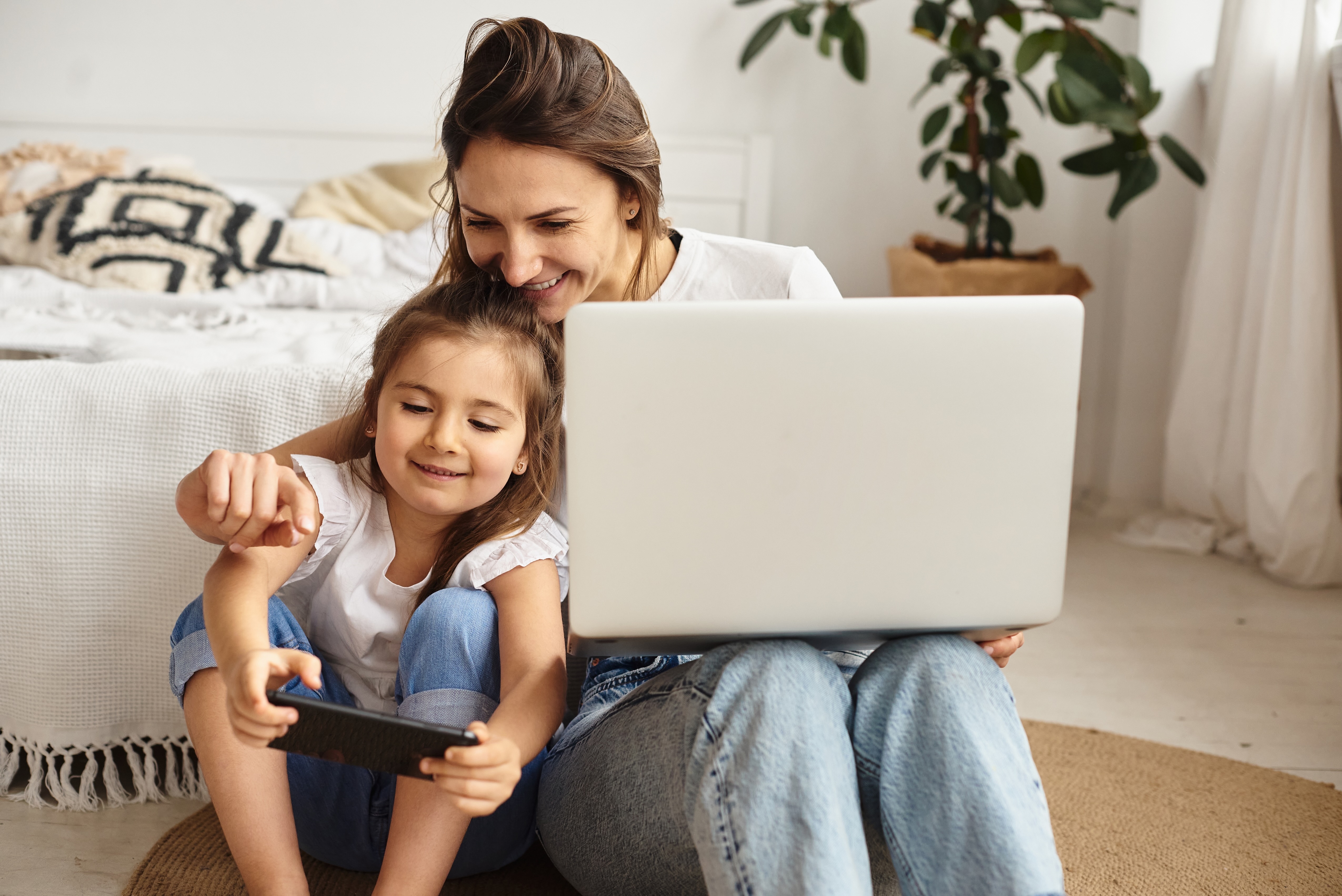 Woman with daughter on laptop
